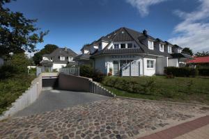 a house with a driveway in front of it at Anna in Ostseebad Koserow