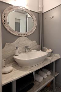 a bathroom with a sink and a mirror at Poplar Mansion in Chalkida
