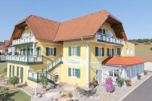 a rendering of a yellow house with a red roof at Hotel Garni Thermenglück in Unterlamm