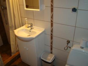 a bathroom with a sink and a toilet at Apartament nad Jeziorem Necko in Augustów +13 photos