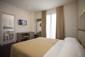 Postel nebo postele na pokoji v ubytování Hotel Bella Lazise