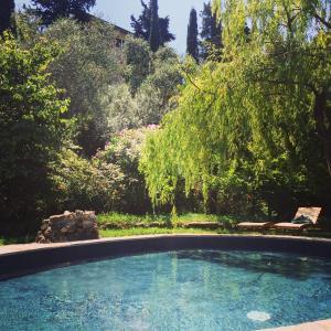 a large swimming pool in a yard with trees at Relais Rantegosa - Holiday home in Chiavari