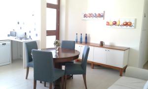 a dining room with a table and blue chairs at Manzoni Suite in Cagliari