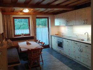 a kitchen with a table and a table and chairs at Haus Benedikt in Heiligenblut