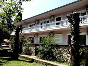 a large white house with a stone wall at Villa Marija Ulcinj in Ulcinj