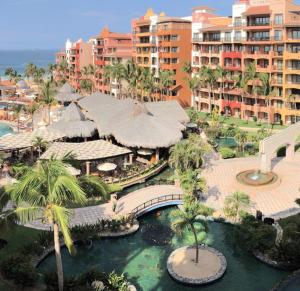 an aerial view of a resort with a bridge and palm trees at Suites at Gr Solmar Lands End Resort and Spa in Cabo San Lucas