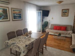 sala de estar con mesa y sofá en Apartments Mima, en Kaštela