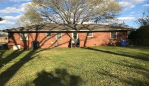 a brick house with a roof on a yard at The Pineapple Lady 13min to Fort Benning in Columbus