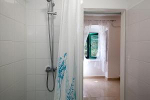 a bathroom with a shower with a shower curtain at King's Garden Studio in Split