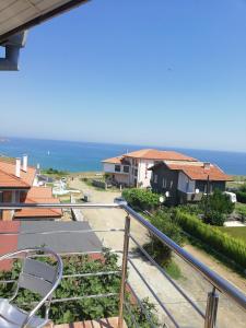 a view of the ocean from a balcony at Къща Мариела in Sinemorets