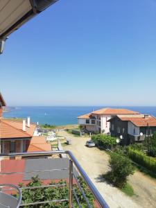 a view of the ocean from the balcony of a house at Къща Мариела in Sinemorets