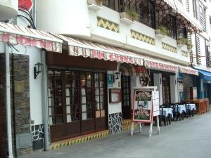 a restaurant with tables and a sign in front of it at Hotel La Cala in Roses