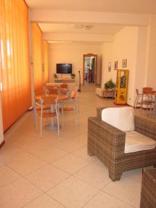 a living room with a table and chairs at Tourist Residence in San Benedetto del Tronto +21 photos
