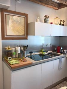 a kitchen with white cabinets and a sink at Venezia Luxury Biennale Design in Venice