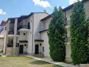 an apartment building with two trees in front of it at Morski Briz in Balchik