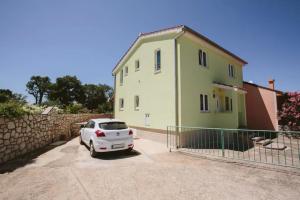 a white car parked in front of a house at Apartments Mester in Sveti Anton