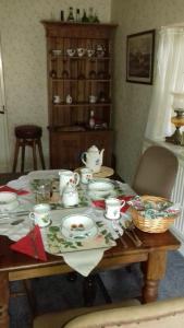 a table that has some plates and cups on it at Hills Farm B&B Laugharne in Laugharne