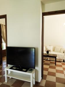 a living room with a flat screen tv on a table at Villa Conifera in Zakynthos Town
