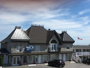 
a large building with a clock on the front of it at Motel Vue Belvédère in Saint-Siméon
