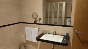 a bathroom with a sink and a mirror at Hotel Nordés in Burela de Cabo +40 photos