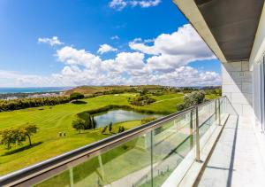 a balcony with a view of a golf course at Crowne Plaza - Caparica Lisbon in Caparica