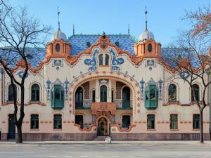 a large building with a blue roof at Apartman Boska Lux in Subotica