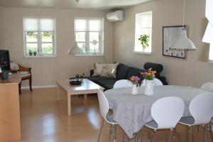 a living room with a table and a couch at Sønderborg Kær Vestermark in Sønderborg