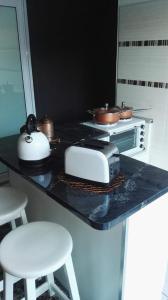 a kitchen with a counter with a toaster and a toaster and a stove at Dankbaar in Bloemfontein