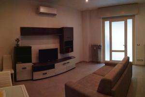 ein Wohnzimmer mit Sofa und Flachbildfernseher in der Unterkunft Appartamento Suite Antiche Terme - Zero Barriere in Acqui Terme + 38 Fotos