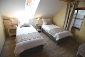 a bedroom with two beds and a window at Janez Rooms in Ljubljana