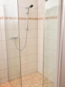 a shower with a glass door in a bathroom at Lüggerts in Ennigerloh