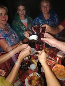 a group of people sitting around a table drinking wine at Apartment MaxinJauri in Makhinjauri