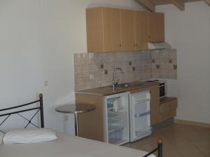 a small kitchen with a sink and a stove at Rania Studios in Lefkada