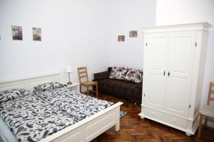 een slaapkamer met een bed en een bank bij Schick apartment in Sibiu +38 foto's
