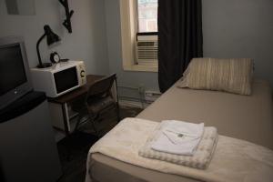 A bed or beds in a room at Saint Lawrence Residences and Suites