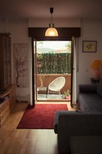 a living room with a couch and a sliding glass door at Casa Arboleda in Ezcaray