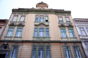 a tall building with many windows on top of it at Schick apartment in Sibiu
