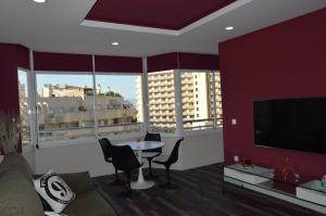 a living room with a couch and a table with chairs at Diamond Torremolinos in Torremolinos