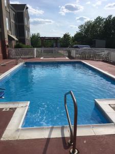 a large swimming pool with a hand rail in the water at Budgetel Inns & Suites in Fairfield