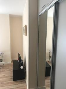 a mirror in a room with a chair and a table at Willa Kalinowa in Sopot