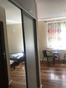 a room with a sliding glass door with a living room at Willa Kalinowa in Sopot