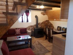a living room with a couch and a wood stove at House SUN Z&B in Žabljak