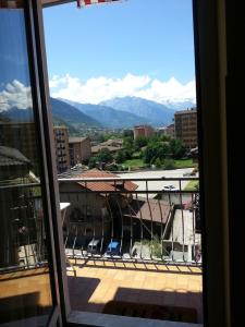 a view from a window of a city with mountains at Arc en ciel in Aosta