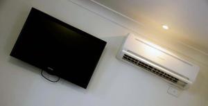 a flat screen tv sitting on top of a table at Oakey Motor Inn in Oakey