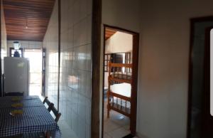 a dining room with a table and a ladder in a room at Jambeiro na praia in Trindade