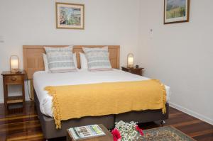 מיטה או מיטות בחדר ב-Kidd Street Cottages