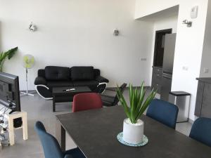 a living room with a table with chairs and a couch at le Perchoir du Lac in Annecy