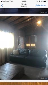 a living room with a couch and a window at Chale dos bomba in Conceição da Ibitipoca