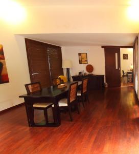 a dining room with a wooden table and chairs at Kebun Villas & Resort in Senggigi
