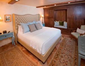 a bedroom with a large bed and a chair at Relaxing 1 Bedroom Condo with Premium Amenities in Vail